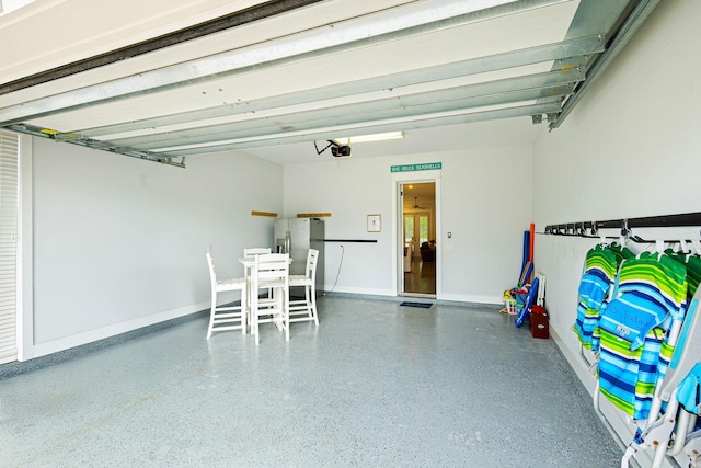 209 Milestone Dr Unit A, Inlet Beach, FL 32461 - garage featuring stainless steel refrigerator with ice dispenser and a garage door opener