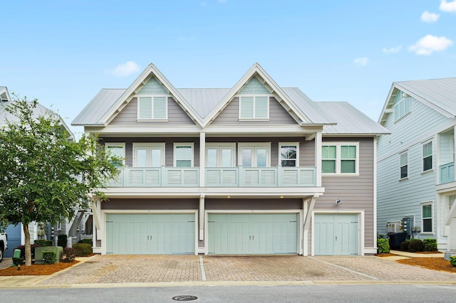 209 Milestone Dr Unit A, Inlet Beach, FL 32461 - townhome / multi-family property featuring a garage, decorative driveway, a metal roof, and a balcony
