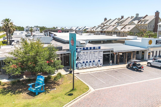209 Milestone Dr Unit A, Inlet Beach, FL 32461 - view of building exterior with uncovered parking and a residential view
