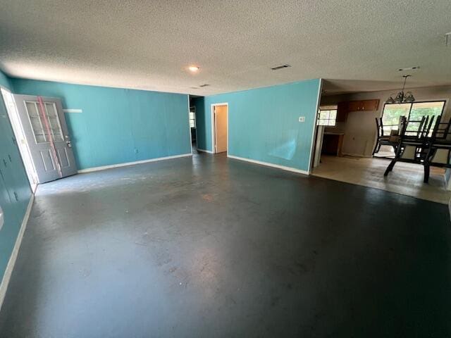 121 Ramsey Branch Rd, Freeport, FL 32439 - unfurnished living room featuring a textured ceiling and finished concrete floors