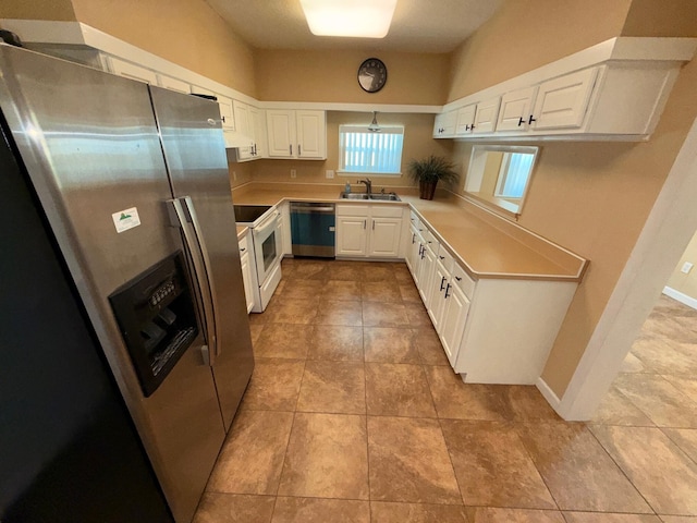 905 Cloverdale Ct, Fort Walton Beach, FL 32547 - kitchen with stainless steel appliances, white cabinetry, light countertops, and light tile patterned floors