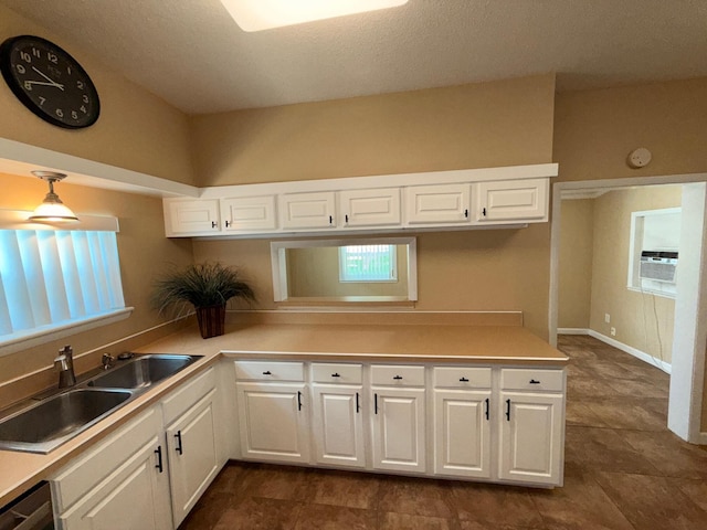 905 Cloverdale Ct, Fort Walton Beach, FL 32547 - kitchen with a peninsula, white cabinetry, light countertops, and cooling unit