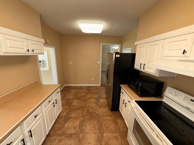 905 Cloverdale Ct, Fort Walton Beach, FL 32547 - kitchen featuring electric range, black microwave, extractor fan, white cabinetry, and freestanding refrigerator