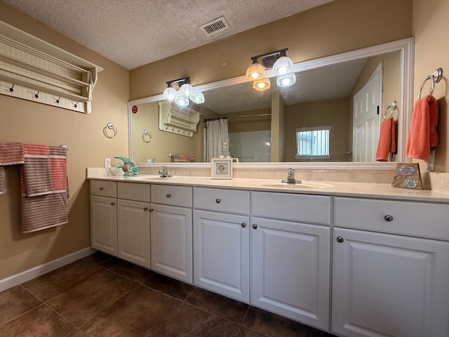 905 Cloverdale Ct, Fort Walton Beach, FL 32547 - full bathroom featuring double vanity, tile patterned flooring, a textured ceiling, and a shower with curtain
