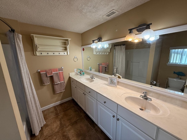 905 Cloverdale Ct, Fort Walton Beach, FL 32547 - bathroom with tile patterned flooring, a textured ceiling, double vanity, and curtained shower