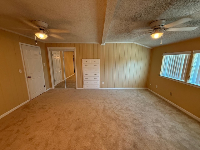 905 Cloverdale Ct, Fort Walton Beach, FL 32547 - spare room featuring ceiling fan, a textured ceiling, carpet flooring, crown molding, and wooden walls
