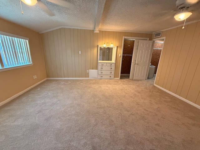 905 Cloverdale Ct, Fort Walton Beach, FL 32547 - unfurnished bedroom featuring a textured ceiling, carpet, ornamental molding, ceiling fan, and wood walls
