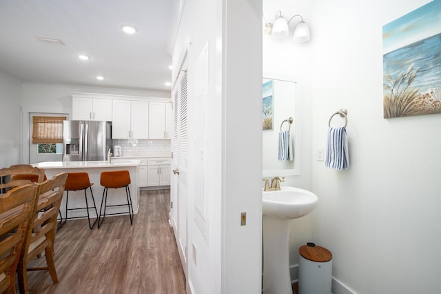 148 N Sand Palm Rd, Freeport, FL 32439 - bathroom featuring backsplash, recessed lighting, and wood finished floors