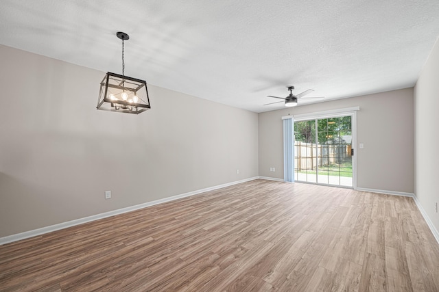 48 4th Ave, Shalimar, FL 32579 - empty room featuring wood finished floors, a chandelier, ceiling fan, and a textured ceiling