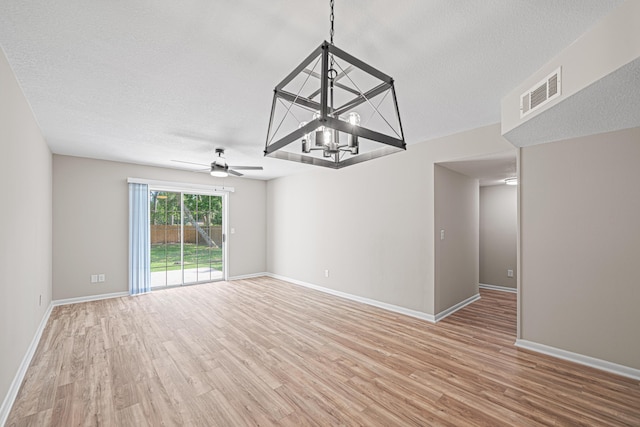 48 4th Ave, Shalimar, FL 32579 - spare room featuring light wood-style flooring, a chandelier, ceiling fan, and a textured ceiling