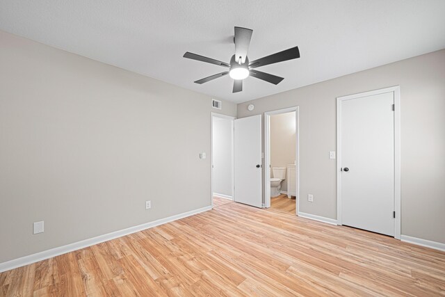 48 4th Ave, Shalimar, FL 32579 - unfurnished bedroom with light wood finished floors, ensuite bathroom, and ceiling fan