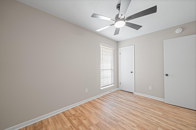 48 4th Ave, Shalimar, FL 32579 - unfurnished bedroom with light wood-style floors, a textured ceiling, and ceiling fan