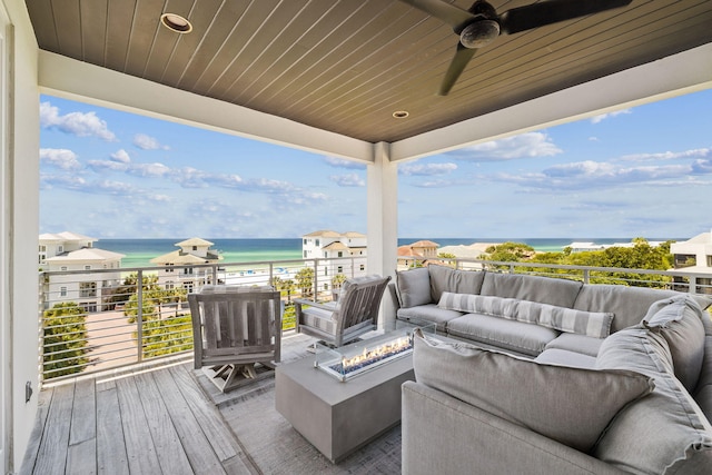 21 Scuttle Hole Rd, Santa Rosa Beach, FL 32459 - wooden deck featuring a water view, an outdoor living space with a fire pit, and a ceiling fan