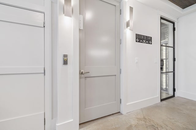 21 Scuttle Hole Rd, Santa Rosa Beach, FL 32459 - corridor featuring finished concrete flooring and baseboards