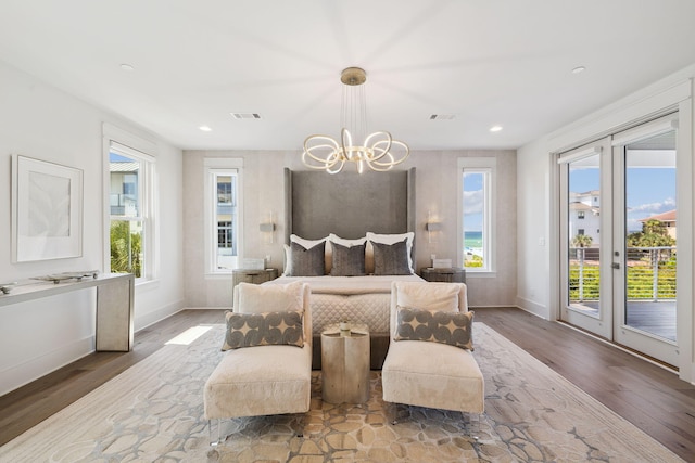21 Scuttle Hole Rd, Santa Rosa Beach, FL 32459 - bedroom with access to exterior, wood finished floors, a chandelier, multiple windows, and recessed lighting