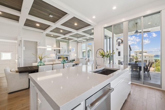 21 Scuttle Hole Rd, Santa Rosa Beach, FL 32459 - kitchen with coffered ceiling, an island with sink, light wood-type flooring, dishwasher, and open floor plan