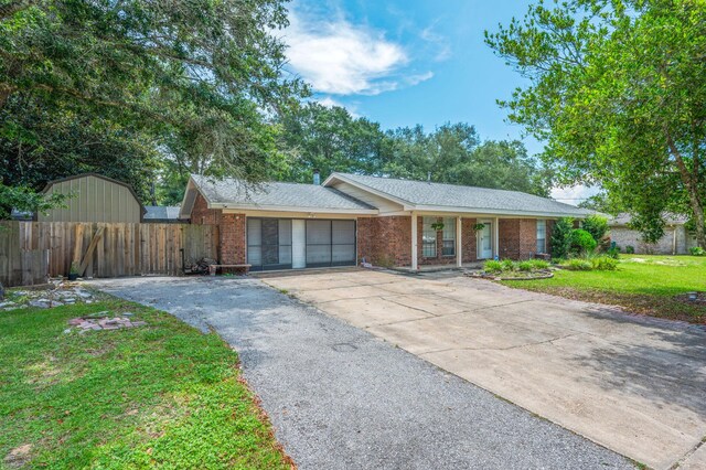 22 James Ave, Shalimar, FL 32579 - ranch-style home with brick siding, driveway, an attached garage, and covered porch