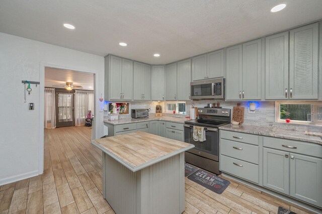 22 James Ave, Shalimar, FL 32579 - kitchen featuring stainless steel appliances, gray cabinets, decorative backsplash, light wood-type flooring, and recessed lighting