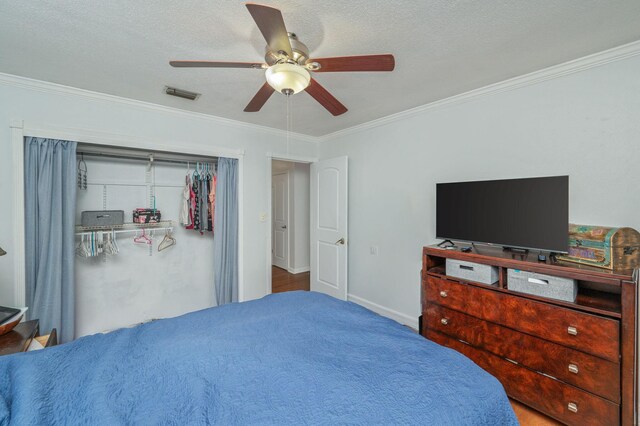 22 James Ave, Shalimar, FL 32579 - bedroom with ornamental molding, a ceiling fan, a closet, and a textured ceiling