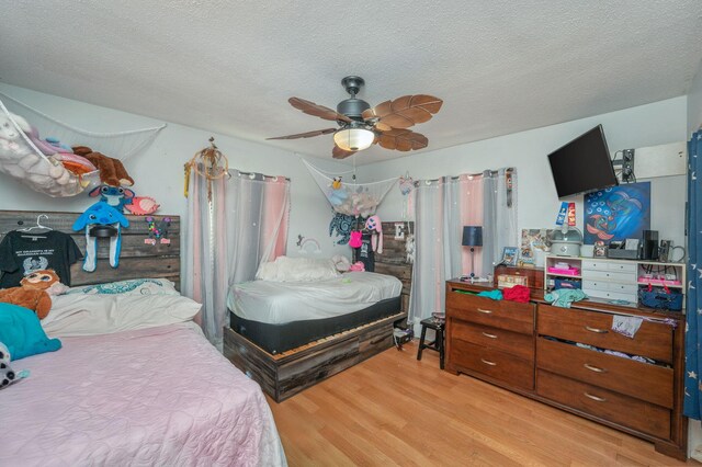 22 James Ave, Shalimar, FL 32579 - bedroom with wood finished floors, a textured ceiling, and a ceiling fan