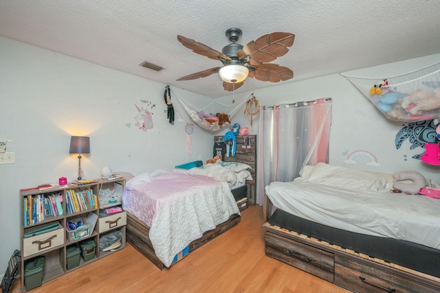 22 James Ave, Shalimar, FL 32579 - bedroom featuring wood finished floors, a textured ceiling, and ceiling fan