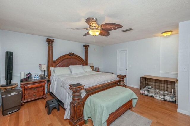 22 James Ave, Shalimar, FL 32579 - bedroom featuring light wood-style flooring, ceiling fan, and a textured ceiling