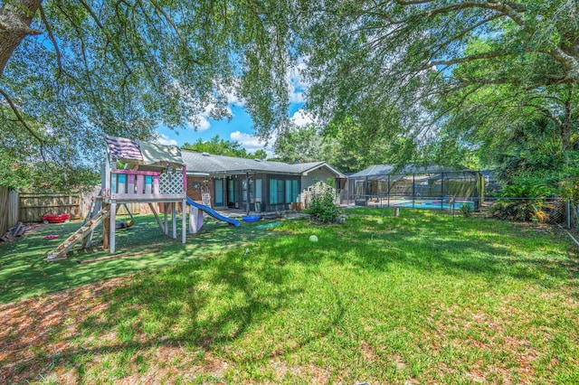 22 James Ave, Shalimar, FL 32579 - fenced backyard with a playground, a swimming pool, and glass enclosure