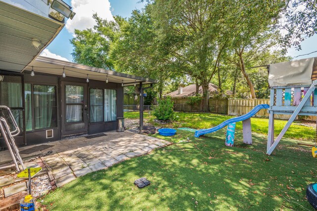 22 James Ave, Shalimar, FL 32579 - fenced backyard with a playground and a patio