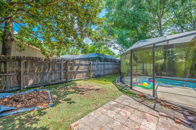 22 James Ave, Shalimar, FL 32579 - fenced backyard featuring a patio and glass enclosure