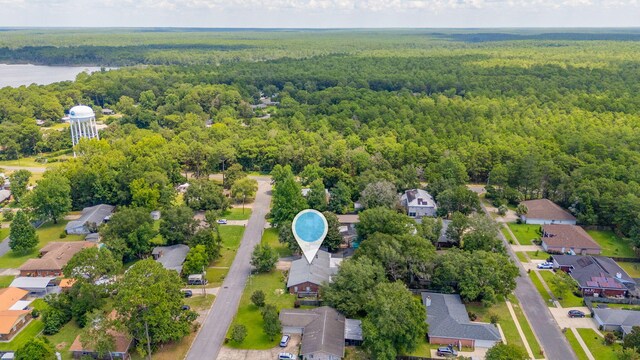 22 James Ave, Shalimar, FL 32579 - aerial perspective of suburban area with a heavily wooded area and a nearby body of water