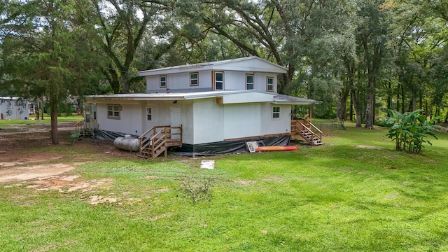 70 River Loop, Ponce De Leon, FL 32455 - rear view of property with stairs, a yard, and view of wooded area