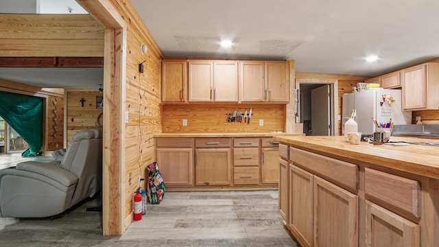 70 River Loop, Ponce De Leon, FL 32455 - kitchen featuring freestanding refrigerator, butcher block countertops, light wood-style floors, light brown cabinets, and wood walls