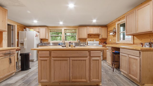 70 River Loop, Ponce De Leon, FL 32455 - kitchen with light brown cabinetry, white refrigerator with ice dispenser, wood counters, a center island with sink, and recessed lighting