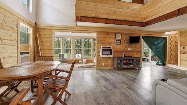 70 River Loop, Ponce De Leon, FL 32455 - dining space with heating unit, wooden walls, healthy amount of natural light, wood finished floors, and a high ceiling