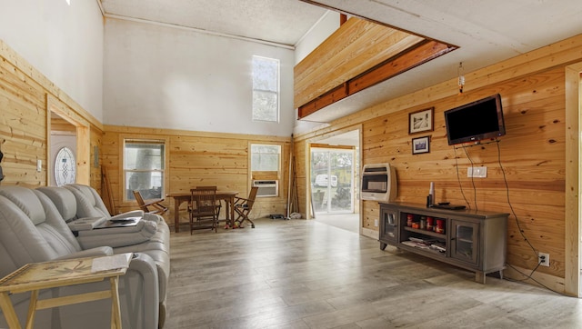 70 River Loop, Ponce De Leon, FL 32455 - living room with wooden walls, heating unit, wood finished floors, cooling unit, and a towering ceiling