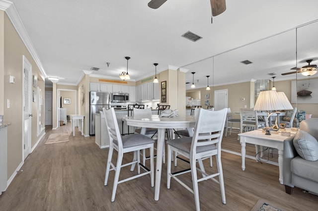 1700 Scenic Highway 98 Unit 101, Destin, FL 32541 - dining area with ceiling fan, wood finished floors, and ornamental molding