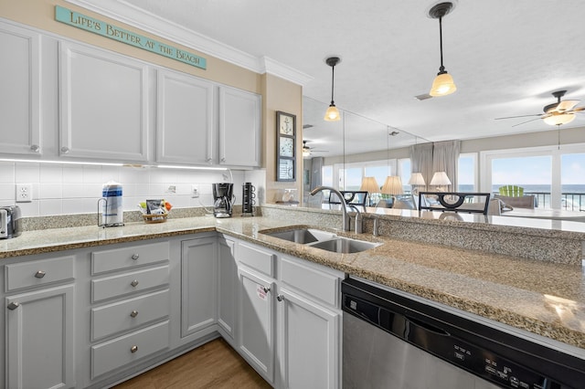 1700 Scenic Highway 98 Unit 101, Destin, FL 32541 - kitchen featuring a ceiling fan, dishwasher, decorative light fixtures, light stone counters, and ornamental molding