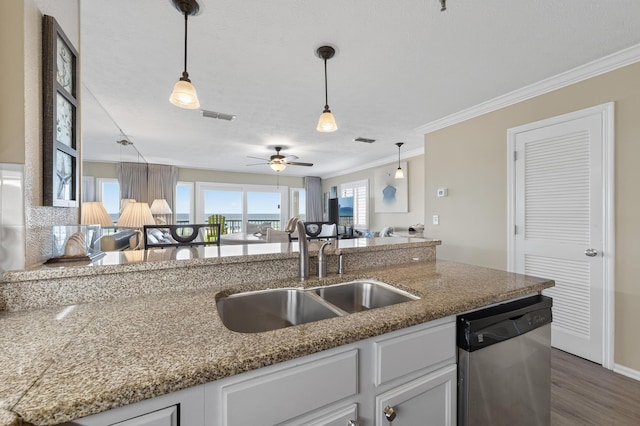 1700 Scenic Highway 98 Unit 101, Destin, FL 32541 - kitchen with stainless steel dishwasher, crown molding, decorative light fixtures, wood finished floors, and white cabinetry