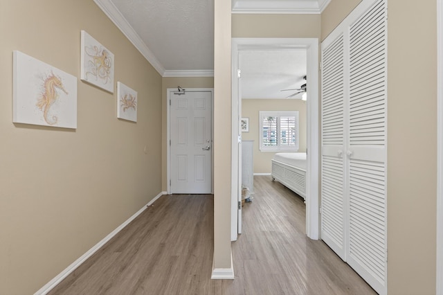 1700 Scenic Highway 98 Unit 101, Destin, FL 32541 - hall featuring light wood-style floors, crown molding, and a textured ceiling