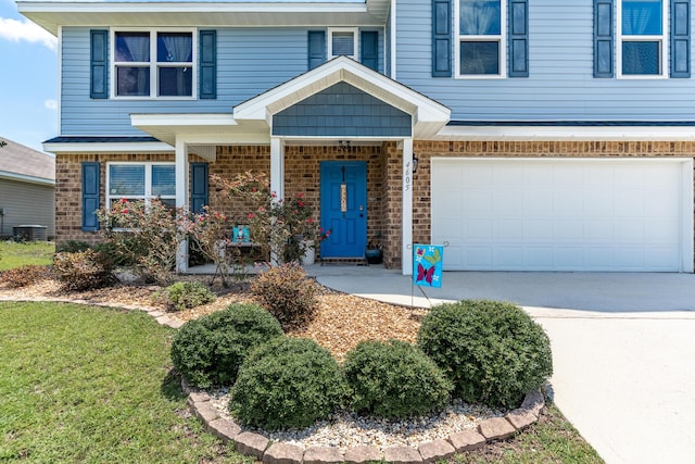 4605 Plover Dr, Crestview, FL 32539 - view of front of home featuring brick siding, a garage, concrete driveway, and a front lawn
