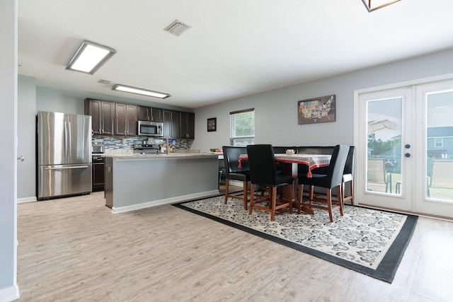 4605 Plover Dr, Crestview, FL 32539 - dining space with light wood-style floors and french doors