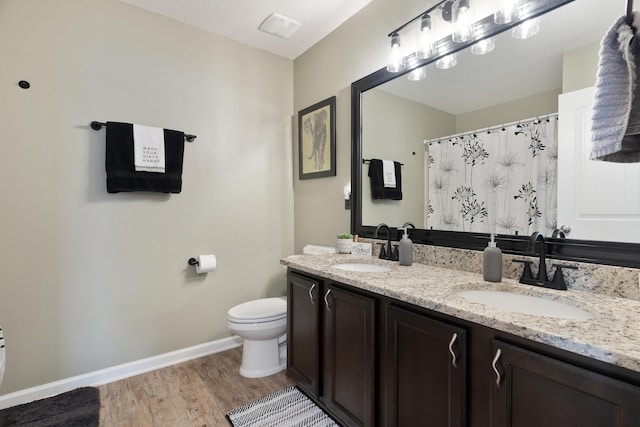 4605 Plover Dr, Crestview, FL 32539 - bathroom featuring double vanity, wood finished floors, and curtained shower