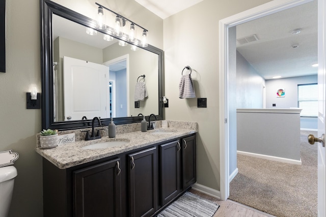 4605 Plover Dr, Crestview, FL 32539 - bathroom with double vanity and wood finished floors