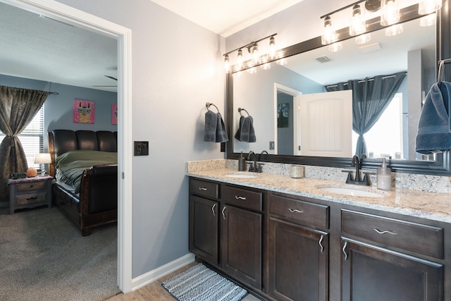 4605 Plover Dr, Crestview, FL 32539 - ensuite bathroom with double vanity and baseboards