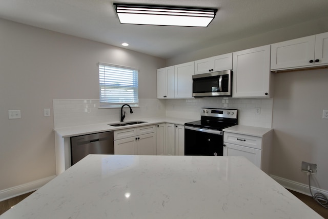 5360 Highview Dr, Crestview, FL 32539 - kitchen with appliances with stainless steel finishes, decorative backsplash, light stone counters, dark wood-style flooring, and white cabinets