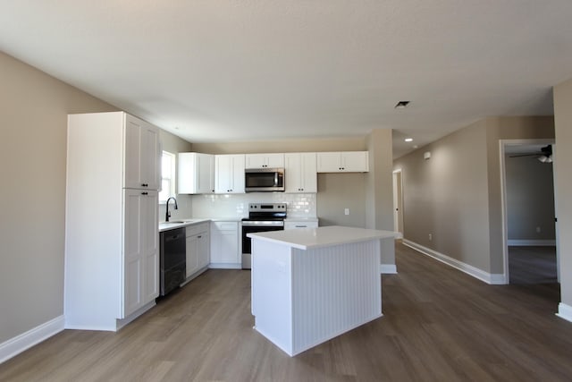 5367 Highview Dr, Crestview, FL 32539 - kitchen featuring stainless steel appliances, light wood-style flooring, white cabinets, light countertops, and a center island