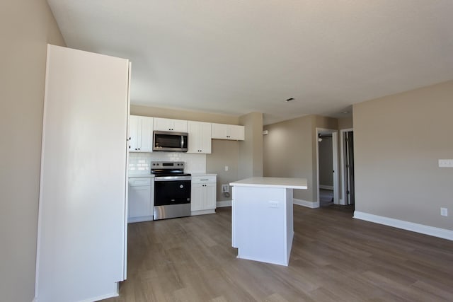 5367 Highview Dr, Crestview, FL 32539 - kitchen featuring appliances with stainless steel finishes, white cabinetry, wood finished floors, and light countertops