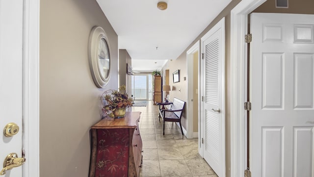 6415 Thomas Dr Unit 1205, Panama City Beach, FL 32408 - hallway featuring baseboards and light tile patterned floors
