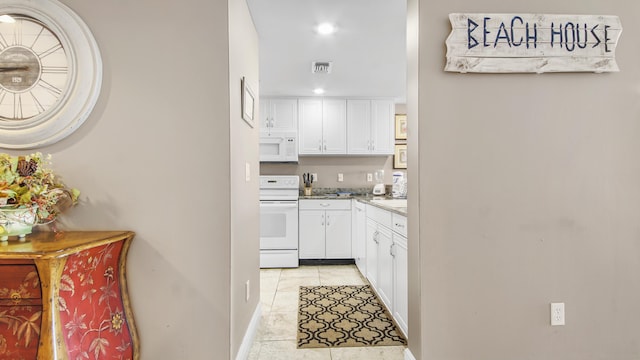 6415 Thomas Dr Unit 1205, Panama City Beach, FL 32408 - kitchen featuring white appliances, white cabinetry, recessed lighting, and light tile patterned floors