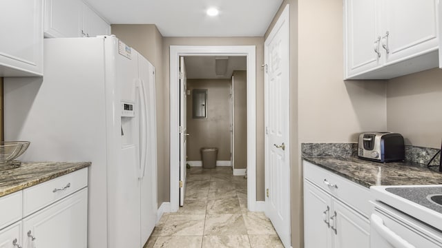 6415 Thomas Dr Unit 1205, Panama City Beach, FL 32408 - kitchen with white refrigerator with ice dispenser, white cabinetry, and dark stone counters
